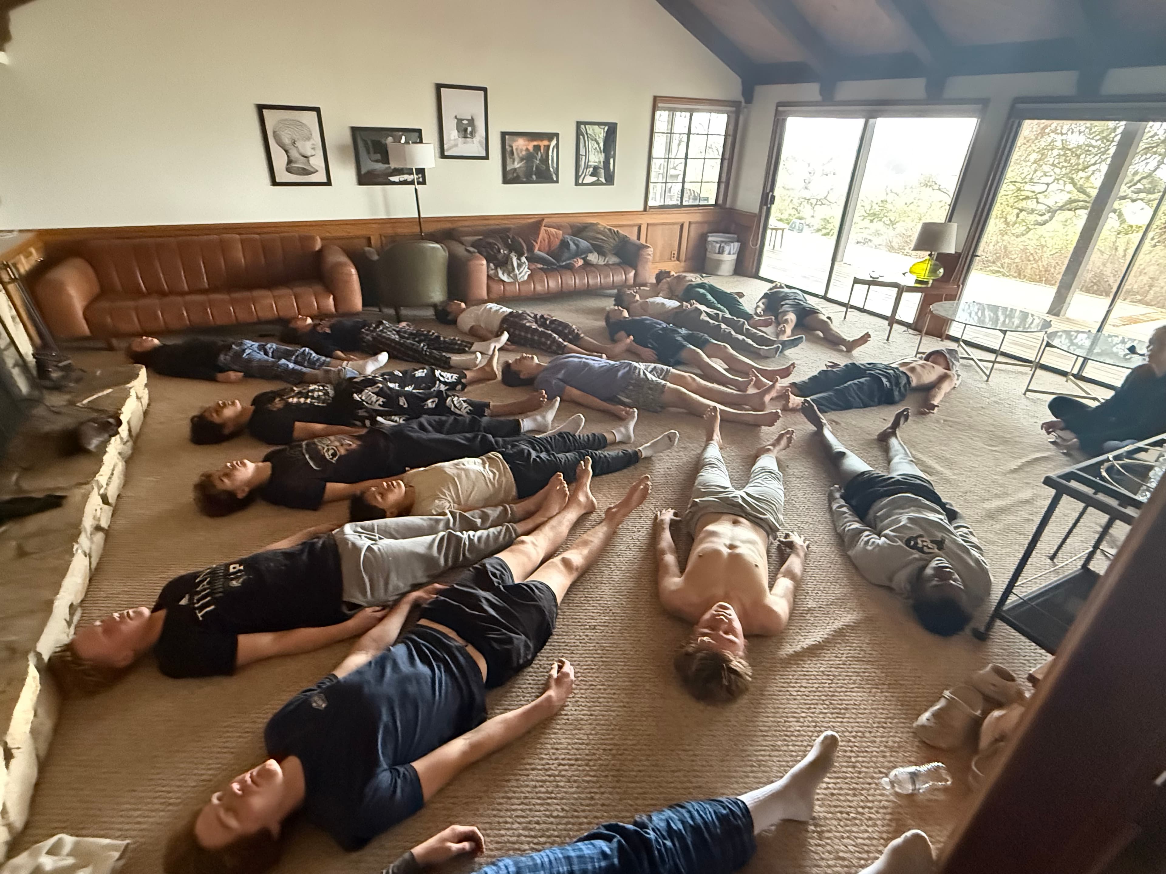 Athletes resting in savasana during a Mind Body Athletes recovery session