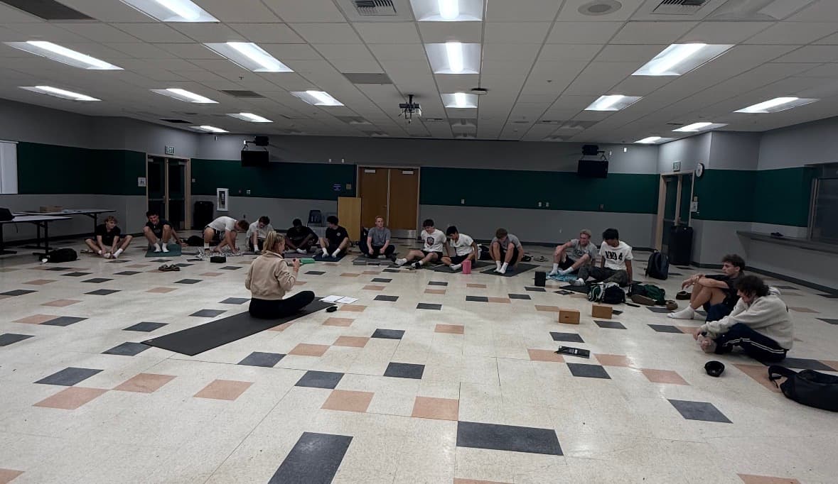 Allie Chapman leading athletes on yoga mats during an ACTIVE series session